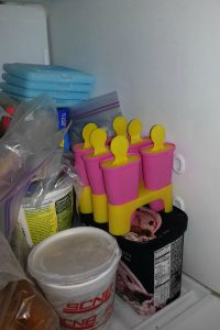Juice pops are in the freezer waiting to get frozen.